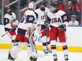 United States forward Luke Toporowski (22) celebrates his goal with goaltender Dustin Wolf (30) during third period Hlinka Gretzky Cup semifinal action in Edmonton on Friday, August 10, 2018.