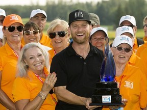 Tyler McCumber celebrates his win at the Syncrude Oil Country Championship with tournament volunteers, at the Edmonton Petroleum Golf and Country Club Sunday Aug. 5, 2018.