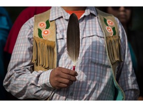 Coldwater Indian band Chief Lee Spahan holds an eagle feather before he and other First Nations leaders respond to a Federal Court of Appeal ruling on the Kinder Morgan Trans Mountain Pipeline expansion, during a news conference in Vancouver, on Thursday August 30, 2018. In a unanimous decision by a panel of three judges, the court says the National Energy Board's review of the project was so flawed that the federal government could not rely on it as a basis for its decision to approve the expansion.