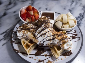 The Choco-Nut Waffle at Cacao 70 in Edmonton Tower has four thick waffles, three covered in whipping cream and one topped with chocolate-drizzled ice cream.