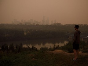Anders Molofy looks over the river valley as smoke from the B.C. wildfires rolls in over Edmonton on Wednesday, Aug. 15, 2018.