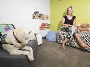Wren, a dog that provides support to children at the Zebra Child Protection Centre with centre director Becci Watson on Wednesday, Aug. 15, 2018 in Edmonton.