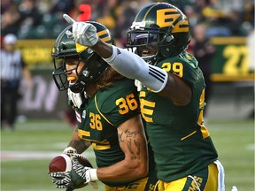 Edmonton Eskimos Mercy Maston (29) helps celebrate Aaron Grymes (36) interception in the fourth quarter against the Calgary Stampeders during CFL action at Commonwealth Stadium, Sept. 8, 2018.
