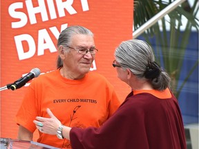 Gisele Wood about to hug her husband Jerry Wood after he spoke about being a student in a residential school at Every Child Matters, orange shirt campaign – remembers the experiences of former students of Indian Residential Schools and is a commitment to ongoing reconciliation in Canada was held at City Hall in Edmonton Friday, September 30, 2016. File photo.