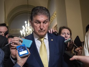 Sen. Joe Manchin (D-WV) is surrounded by reporters after meeting privately with Senators Jeff Flake (R-AZ), Susan Collins (R-ME), and Lisa Murkowski (R-AK) following the Senate Judiciary Committee hearing with Dr. Christine Blasey Ford and Supreme Court nominee Judge Brett Kavanaugh on Capitol Hill.