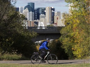 Downtown Edmonton is visible in the background as a cyclist rides along 87 Avenue near 106A Street, in Edmonton Tuesday Sept. 18, 2018.