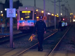 Emergency crews work at the scene after a pedestrian was hit by an LRT train between Churchill and Coliseum stations near 82 Street and 111 Avenue, in Edmonton on Thursday Sept. 19, 2018.