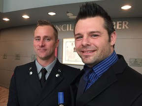 Firefighter Chris Scott, left, was off-duty when he came across David Liska trapped in a burning vehicle on April 16. He got a standing ovation for his bravery at a city council meeting on Tuesday, Sept. 18, 2018.
