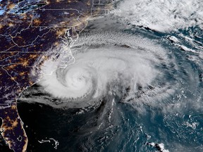 This NOAA/RAMMB satellite image taken at 11:30 UTC on September 13, 2018, shows Hurricane Florence beginning to hit the US east coast.