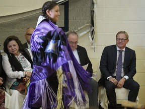 Community elder Betty Letendre, left, and Alberta Education Minister David Eggen, right, watch students perform a traditional dance at Ben Calf Robe-St. Clare School in Edmonton on Monday,  Sept. 10, 2018.