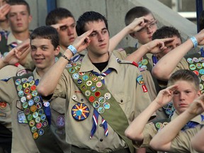 In this July 3, 2010, file photo, Boy Scouts salute during the Stadium of Fire in Provo, Utah. The Mormon church's new youth program it will roll out in 2020 when it cuts all ties with Boy Scouts of America will still include outdoor and adventure activities even as the initiative becomes more gospel-focused, the faith confirmed Friday, Sept. 21, 2018.