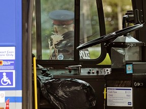 A blood-stained window of an Edmonton Transit System bus parked at the Millwoods Transit Centre on Wednesday, Sept. 26, 2018. A bus driver was hospitalized after he was stabbed at least 13 times by a youth.