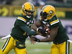 Edmonton Eskimos quarterback Mike Reilly (13) hands the ball to C.J. Gable (2) against the Winnipeg Blue Bombers during first half CFL action on Saturday, Sept. 29, 2018 in Edmonton.