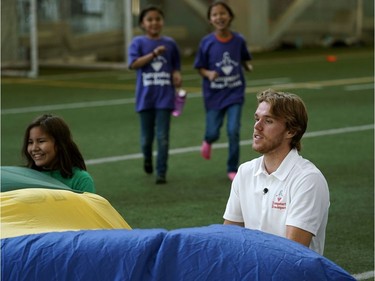 Edmonton Oilers star Connor McDavid , right, participates in the Jumpstart Games with 300 children at the Commonwealth Community Recreation Centre on Sept. 11, 2018. McDavid and the Edmonton Oilers Community Foundation gave $85.000 over three years to an initiative that promotes sports and physical activity in Indigenous communities.