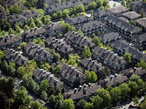 The Canadian Real Estate Association says home sales rose by 0.9 per cent between July and August, marking the fourth consecutive monthly increase. A neighbourhood of townhouses is seen in an aerial view in Richmond, B.C., on Wednesday May 16, 2018.