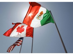 In this April 21, 2008 file photo, national flags of the United States, Canada, and Mexico fly in the breeze in New Orleans.