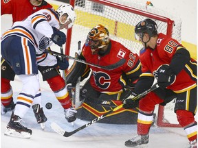 Flames Tyler Parsons minds the net duirng a goal mouth scramble during an NHL pre-season rookie game between the Edmonton Oilers and Calgary Flames in Calgary on Sunday, September 9, 2018.