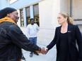 Governor General Julie Payette, right, shakes hands with Corsini Alexander in Gatineau, Que. on Monday, September 24, 2018, who was left homeless after a tornado caused extensive damage Friday to a Gatineau neighbourhood forcing hundreds of families to evacuate their homes.