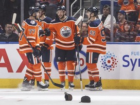 Edmonton Oilers Oscar Klefbom (77), Connor McDavid (97), Ty Rattie (8) and Ryan Nugent-Hopkins (93) celebrate a goal against the Vancouver Canucks during third period preseason action in Edmonton on Tuesday September 25, 2018.