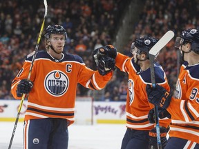 Edmonton Oilers' Connor McDavid (97), Ty Rattie (8) and Ryan Nugent-Hopkins (93) celebrate a goal against the Arizona Coyotes during second period preseason action in Edmonton on Thursday September 27, 2018.