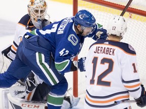 Edmonton Oilers Jakub Jerabek looks on as Vancouver Canucks left wing Sven Baertschi (47) puts a shot past Edmonton Oilers goaltender Cam Talbot (33) during second period NHL pre-season action at Rogers Arena in Vancouver, Tuesday, Sept, 18, 2018. THE CANADIAN PRESS/Jonathan Hayward