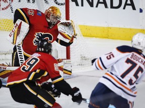 Edmonton Oilers' Evan Bouchard scores on Calgary Flames goalie David Rittich during first period preseason NHL hockey action in Calgary, Monday, Sept. 17, 2018. THE CANADIAN PRESS/Jeff McIntosh