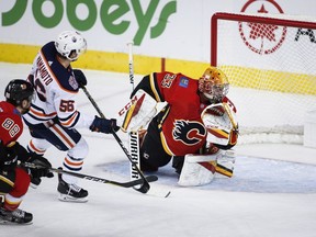 Edmonton Oilers' Kailer Yamamoto scores on Calgary Flames' goalie David Rittich during first period preseason NHL hockey action in Calgary, Monday, Sept. 17, 2018. THE CANADIAN PRESS/Jeff McIntosh
