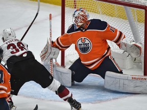 Edmonton Oilers goalie Mikko Koskinen makes a save off Arizona Coyotes Christian Fischer during NHL preseason action at Rogers Place in Edmonton, September 27, 2018.