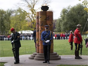 Officers take part in a public ceremony at the Alberta Legislature grounds to remember the 100 men and women who have died in the line of duty in Alberta.