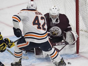 Edmonton Oilers rookie Cameron Hebig shoots the puck on NAIT - MacEwan All- Stars goaltender Marc-Olivier Daigle during first period action on Tuesday, Sept. 11, 2018 at Rogers Place. Greg Southam/Postmedia