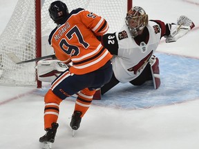 Edmonton Oilers Connor McDavid (97) scores the game winning goal in overtime on Arizona Coyotes goalie Antti Raanta during NHL pre-season action at Rogers Place in Edmonton, September 27, 2018. Ed Kaiser/Postmedia