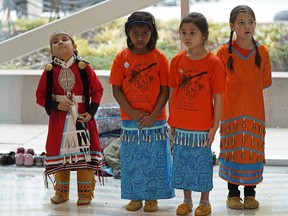 Avianna Burnstick, Abhinitha Arun, Erich Coloma, and Ruby Loane (left to right) were joined by hundreds of people who attended an Orange Shirt Day celebration at Edmonton City Hall on Friday September 28, 2018. Indigenous, community and government leaders, and students all across Alberta, wore orange shirts on Friday September 28, 2018 for Orange Shirt Day. This day provides the opportunity to discuss all aspects of residential schools and to help continue the work of reconciliation. (PHOTO BY LARRY WONG/POSTMEDIA)