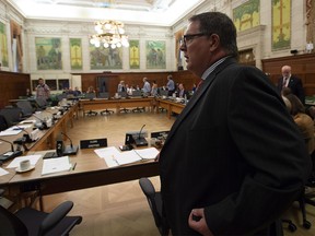 Chair of the House of Commons Natural Resources committee James Maloney prepares to take his seat for a special meeting on Parliament Hill in Ottawa, Tuesday Sept. 4, 2018.