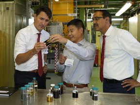 Prime Minister Justin Trudeau (left) and Amarjeet Sohi (right, Minister of Natural Resources) meet with Dr. Jinwen Chen (Director of Hydrocarbon Conversion) at the Canmet Energy Devon Research Centre on September 4, 2018. (PHOTO BY LARRY WONG/POSTMEDIA)