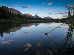 The last rays of daylight catch the clouds and mountain peaks above Kananaskis Lakes southwest of Calgary. File photo.