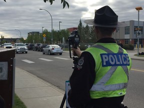 Const. Brad Chipchase monitors the speed of vehicles near Dr. Donald Massey School  on the first day of class. Police gave out four tickets during the morning radar blitz.(Photo by Dustin Cook)