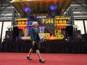 Alberta Premier Rachel Notley walks past a heavy hauler truck during the Suncor Fort Hills grand opening in Fort McMurray, Alta, on Monday, Sept. 10, 2018.