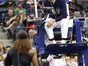 Chair umpire Carlos Ramos talks with Serena Williams during the women's final of the U.S. Open tennis tournament against Naomi Osaka, of Japan, Saturday, Sept. 8, 2018, in New York.