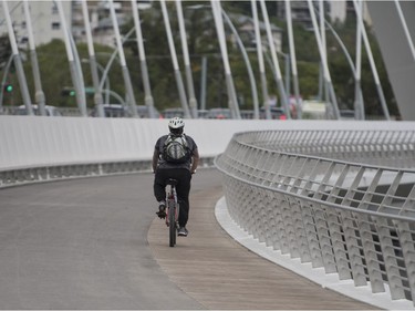 A cyclist crosses the Walterdale Bridge walkway in Edmonton on Monday Aug.27, 2018