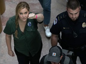 Comedian Amy Schumer is led away after she was arrested during a protest against the confirmation of Supreme Court nominee Judge Brett Kavanaugh October 4, 2018 at the Hart Senate Office Building on Capitol Hill in Washington, DC.