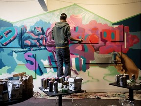 Graffiti artist  AJA Louden works on a piece inside The Aviary, 9314 111 Ave., in Edmonton Wednesday Oct. 3, 2018. Louden along with artists Evan Brunt and Jordan Ernst are creating large scale graffiti pieces inside The Aviary as part of the Smoke City Art Show. Photo by David Bloom
