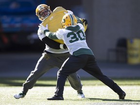 Christophe Normand (37) and Martese Jackson (30) take part in an Edmonton Eskimos' team practice at Commonwealth Field, in Edmonton Wednesday Oct. 3, 2018.