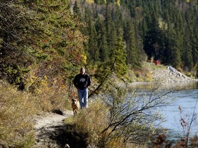 Brian Cornforth walks along a trail near the North Saskatchewan River (south of Hawrelak Park) with his dog Charlie, in Edmonton Thursday Oct. 4, 2018.
