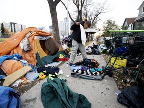 Kenny Cardinal packs up his tent and belongings along 105A Avenue near 96 Street, in Edmonton Monday Oct. 15, 2018. Cardinal had been camping at the site until he says he was told to move by police.