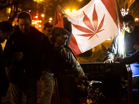 A small group of Edmontonians celebrate marijuana legalization in a park near Whyte Avenue and Gateway Boulevard after midnight in Edmonton on Wednesday, Oct. 17, 2018. The park is one of Edmonton's new smoking zones.