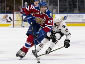 The Edmonton Oil Kings' Matthew Robertson (22) is chased by the Red Deer Rebels' Reese Johnson (17) during first period WHL action at Rogers Place in Edmonton on Friday, Oct. 19, 2018.