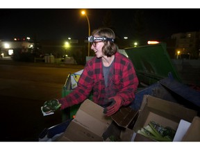 Anna Gnida shows a friend the avocados she found while dumpster diving for food in Edmonton on Friday, Oct. 19, 2018.