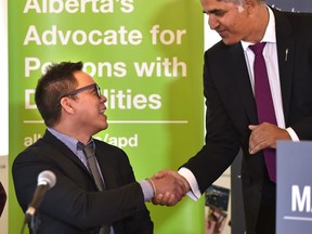 Tony Flores is the new Alberta Advocate for Persons with Disabilities and shaking his hand is Minister of Community and Social Services Irfan Sabir in Edmonton, October 30, 2018. Ed Kaiser/Postmedia