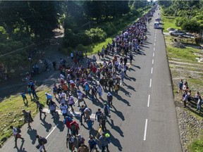 An aerial view on Oct. 21, 2018, of Honduran migrants heading in a caravan to the U.S., is seen on the road linking Ciudad Hidalgo and Tapachula, Chiapas state, Mexico.