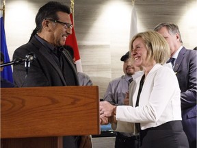 Chief Billy Joe Laboucan, left, and Alberta Premier Rachel Notley shake hands after announcing the Lubicon Lake Band land claim settlment in Edmonton on Wednesday, Oct. 24, 2018. The Lubicon Lake Band members have voted in favour of a settlement to their long-standing land claim.